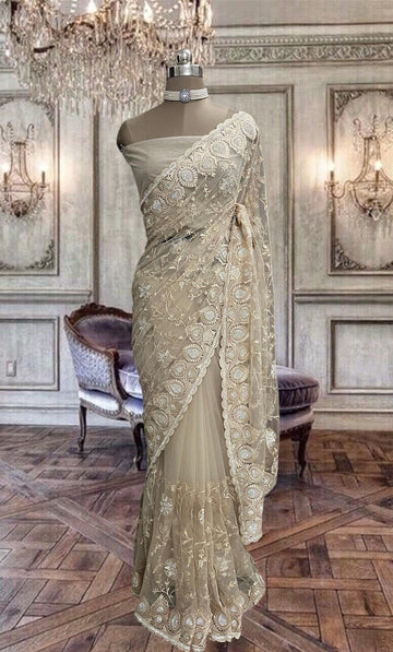 Beautiful beige net saree with thread and stone work